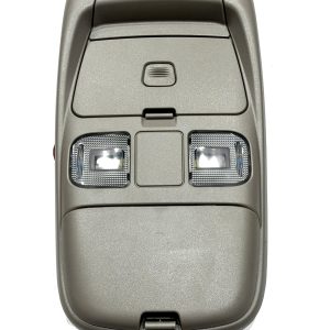Overhead car console with two reading lights and a central control switch, viewed from above